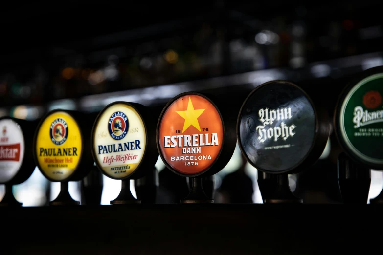 a row of beer taps lined up next to each other