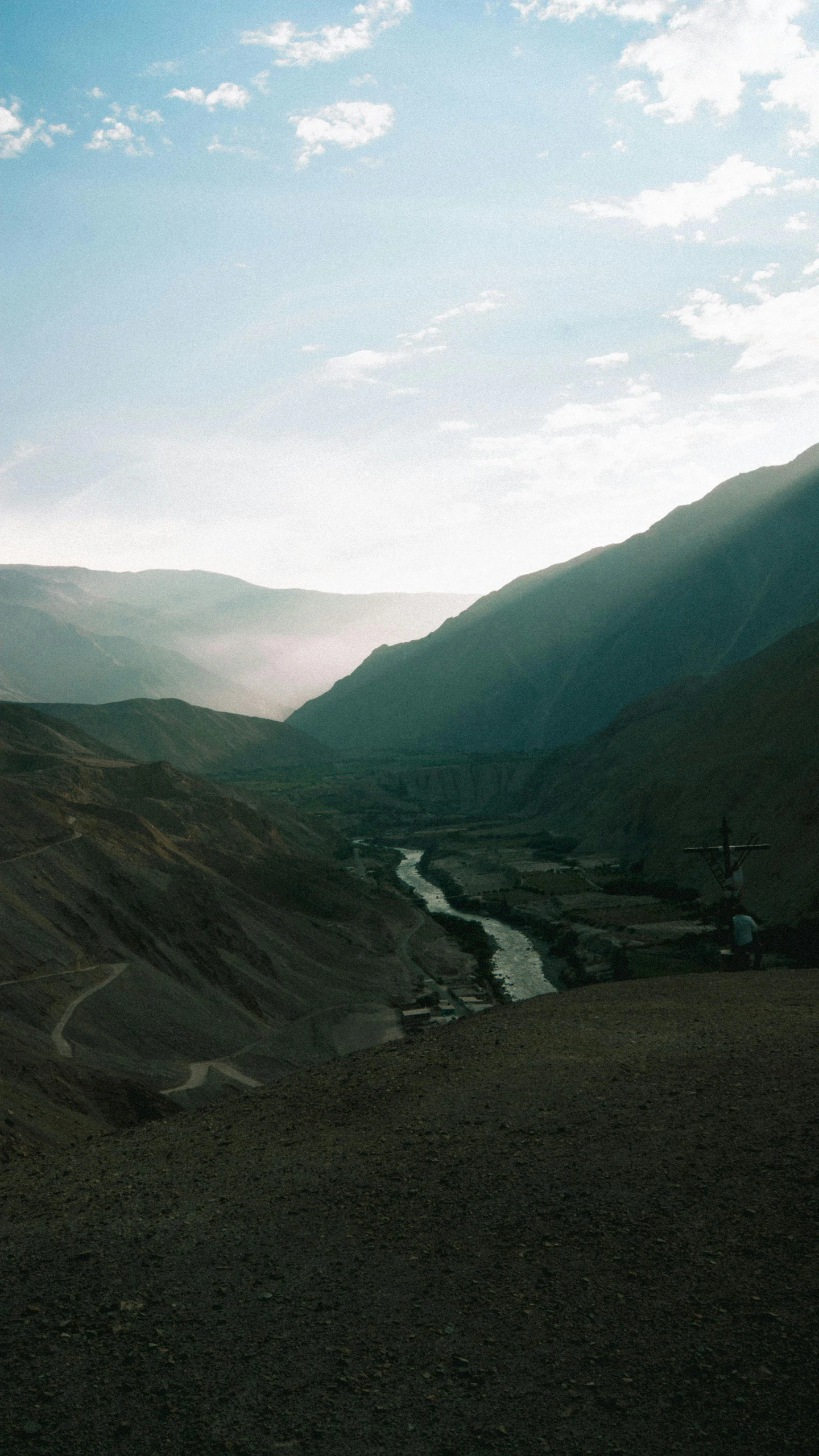 a view of the mountains and river from the top