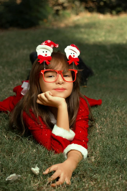 a  wearing a santa outfit laying on the grass