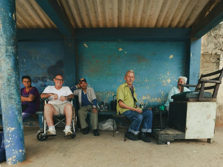 a group of older men in wheel chairs sitting