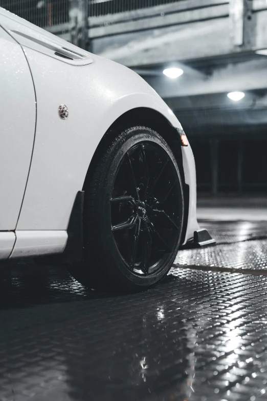 a white sports car on a rainy night