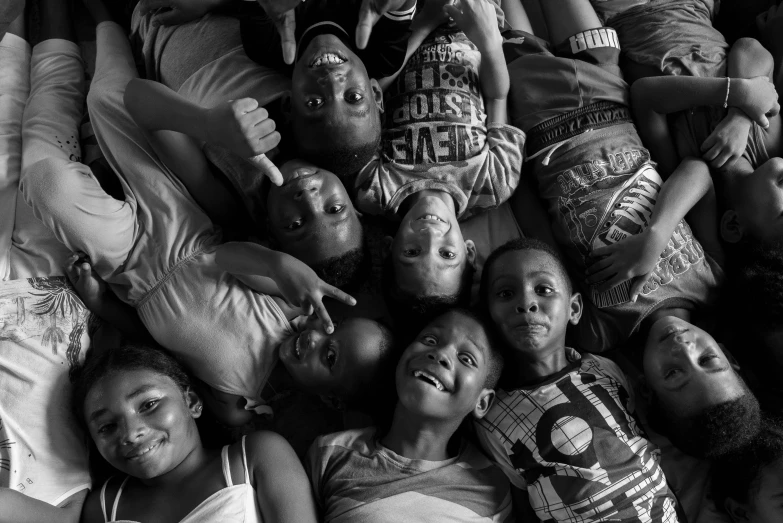 a group of children laying together on a bed