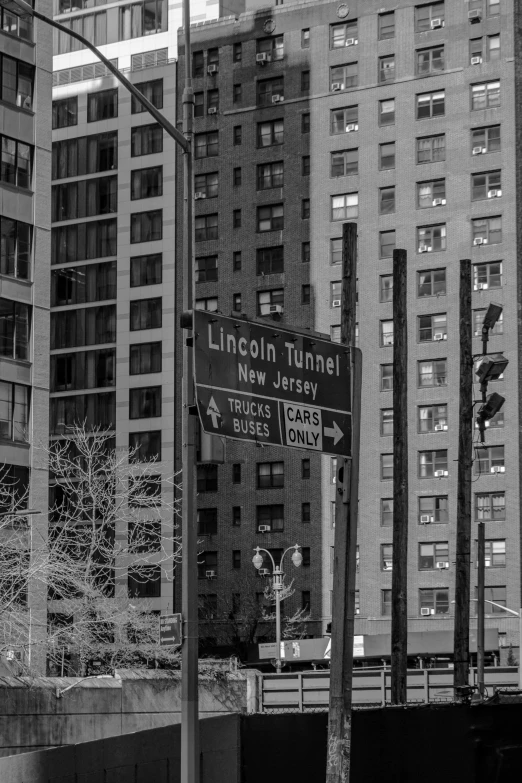 a street sign is posted in front of tall buildings