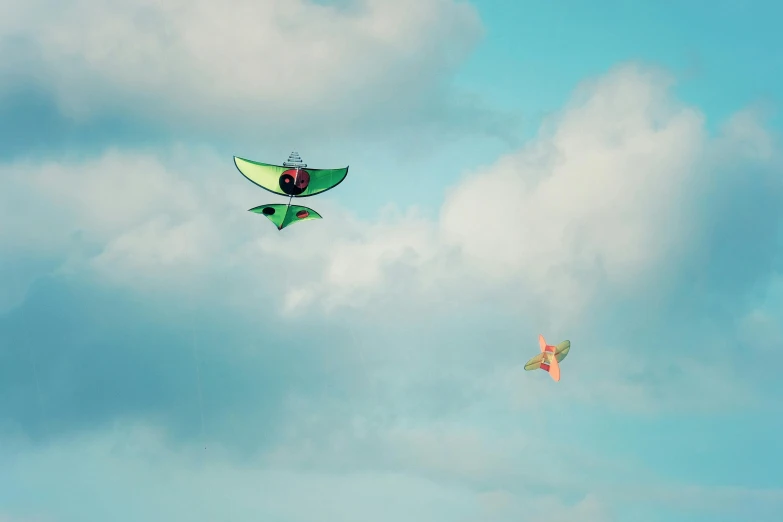 two kits that are in the air on a cloudy day