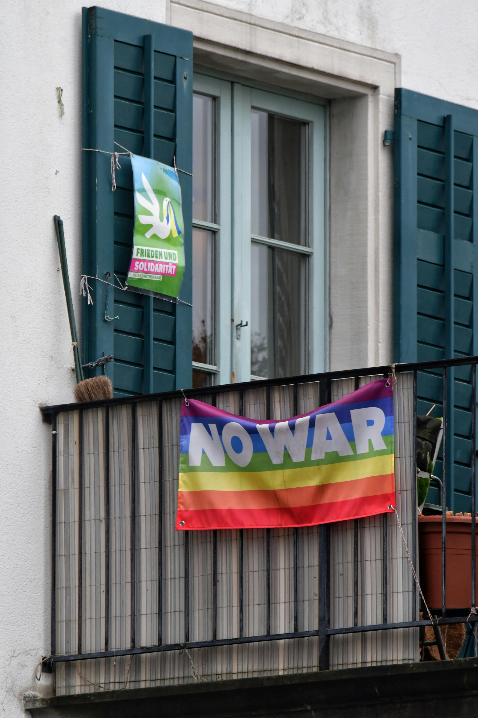 a rainbow flag hung on a balcony of a building