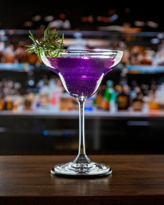 a cocktail in a glass on a bar table