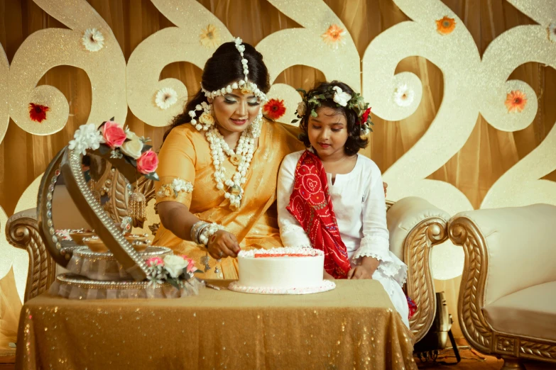 two women are in front of a wedding cake