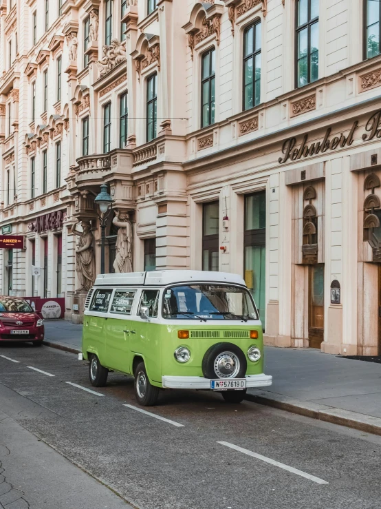 a green van is going down the road