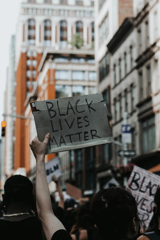 people in a protest march holding up signs