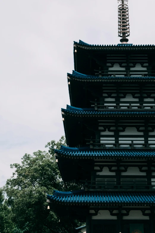 a very tall tower sitting next to a tree