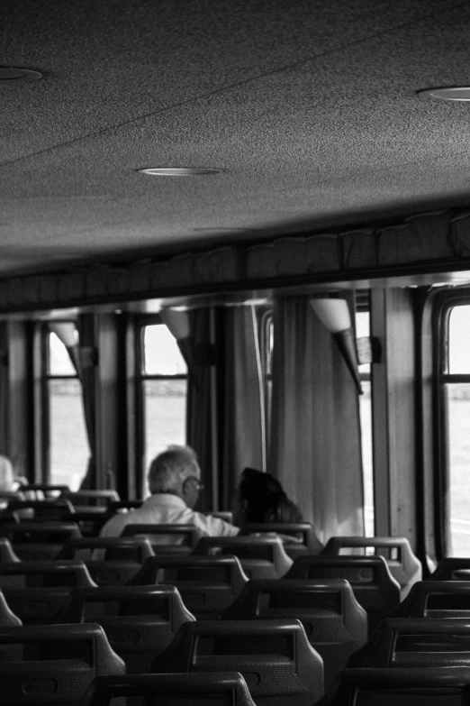 a row of chairs sitting on a boat in a room