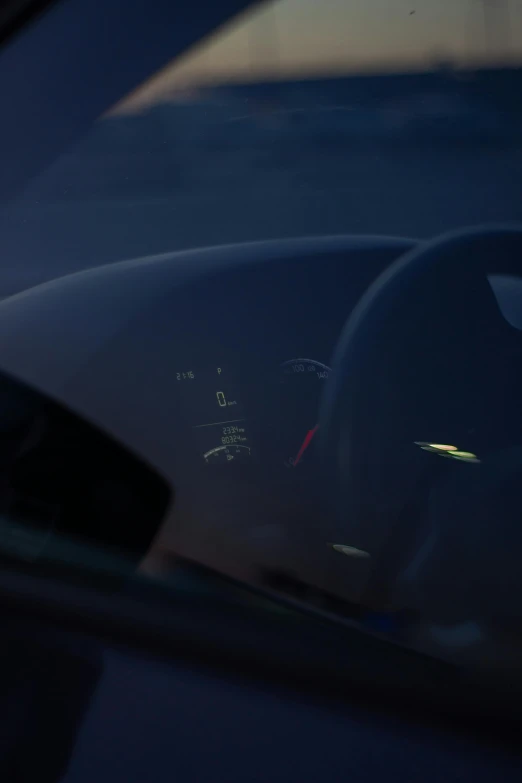 the dashboard of an automobile in front of a window