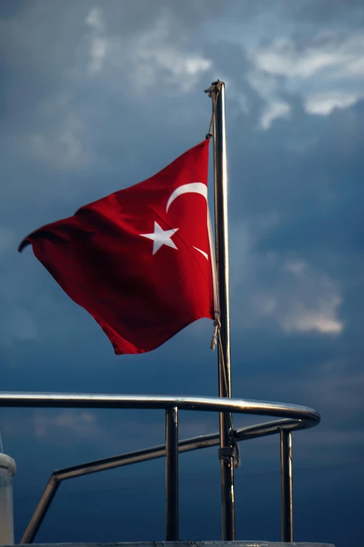 a flag on a sailboat flying in the sky