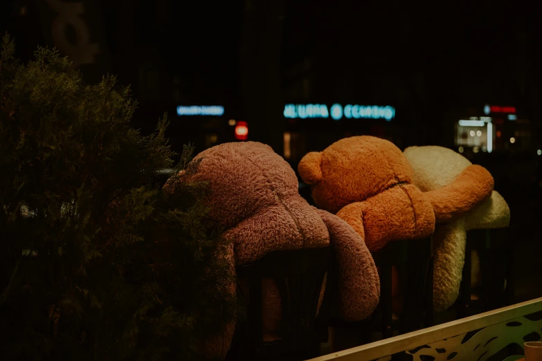 there are several teddy bears placed on a fence together