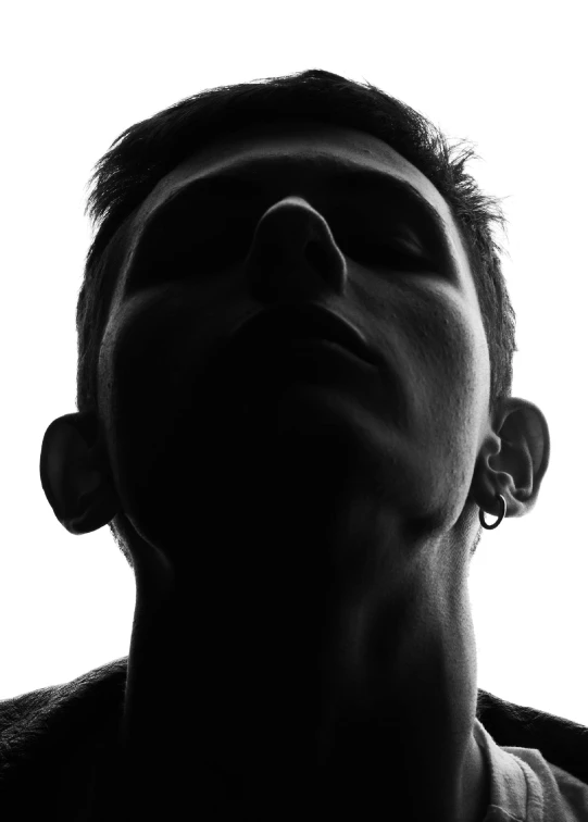 black and white pograph of man with nose pressed against the sun