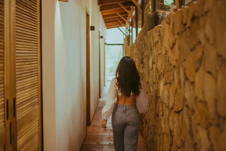 woman walking down a walkway with her back to the camera