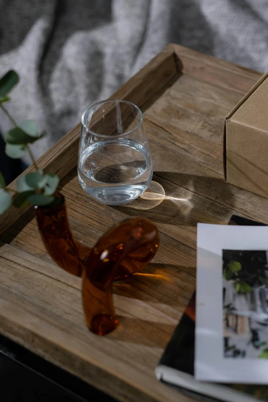 glass of water next to an empty brown box