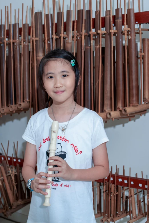 girl standing in front of a large rack of musical instruments