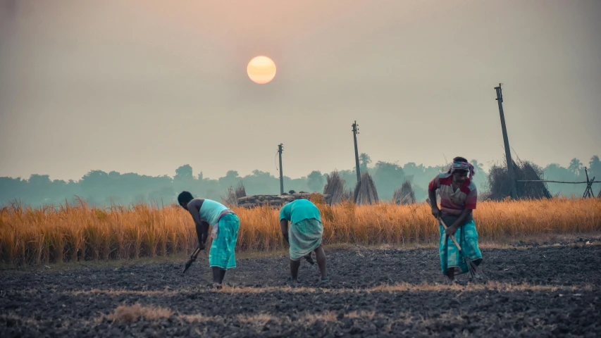 three men are standing near each other in the field