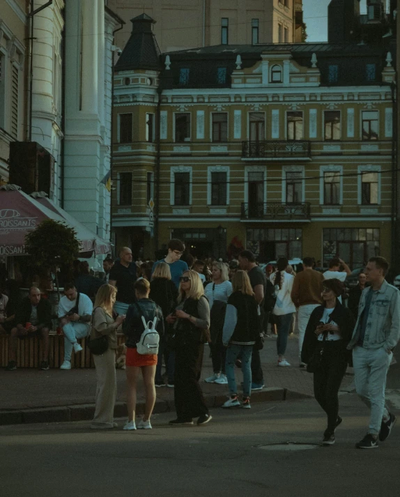 people are walking down the street with tall buildings in the background