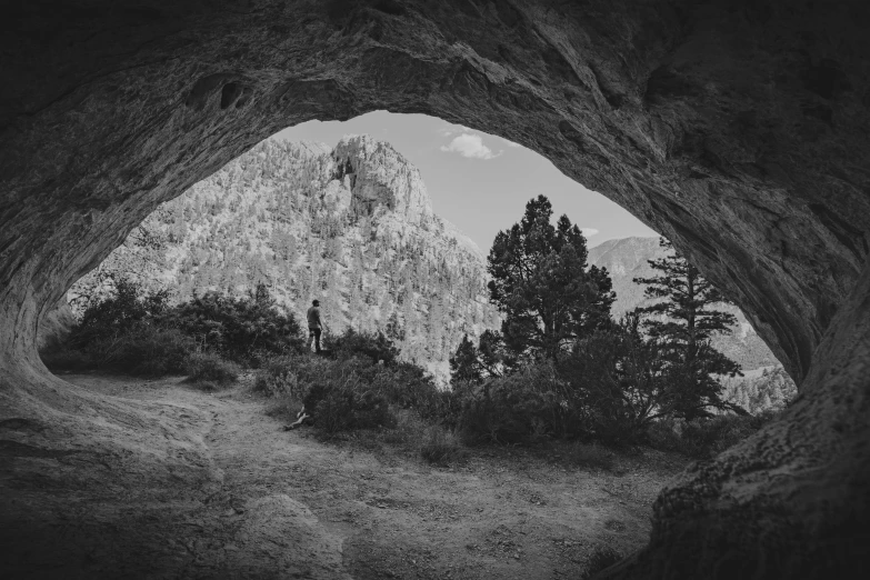 a view of the mountains from inside an arch