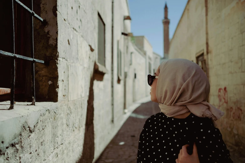 a woman wearing glasses looking out from the side