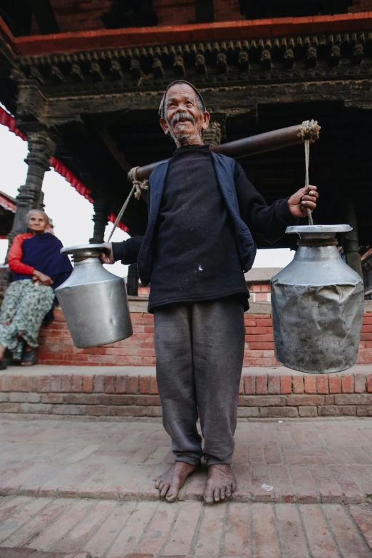 a person with two buckets on their back