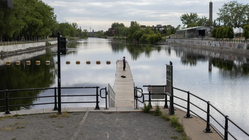 a wooden dock surrounded by water and trees