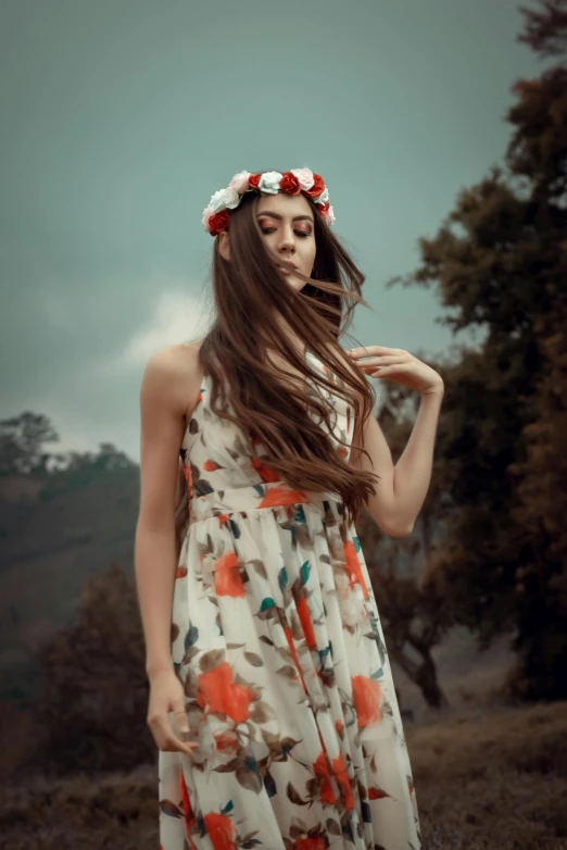 a woman in dress standing outside with long hair