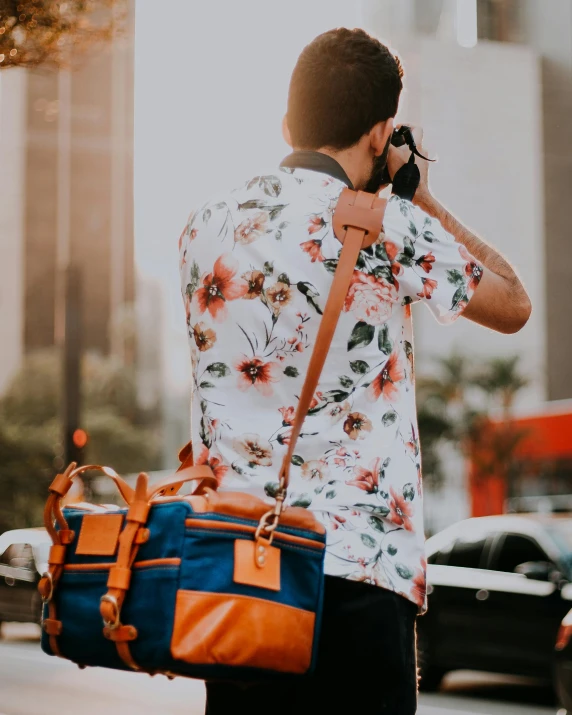 a man standing on the street holding a cell phone to his ear