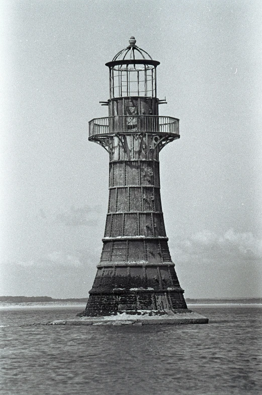 a lighthouse is shown in the middle of the ocean