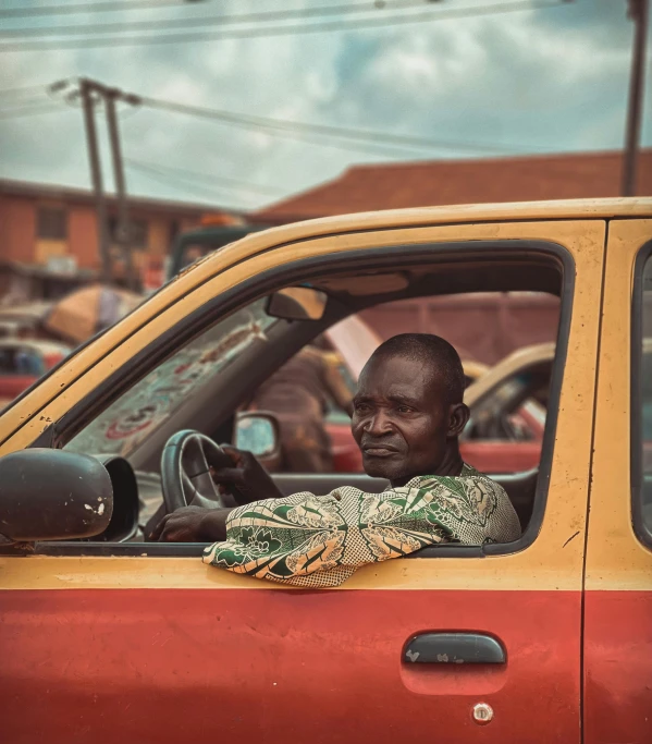 a man sitting in the cab of a red truck