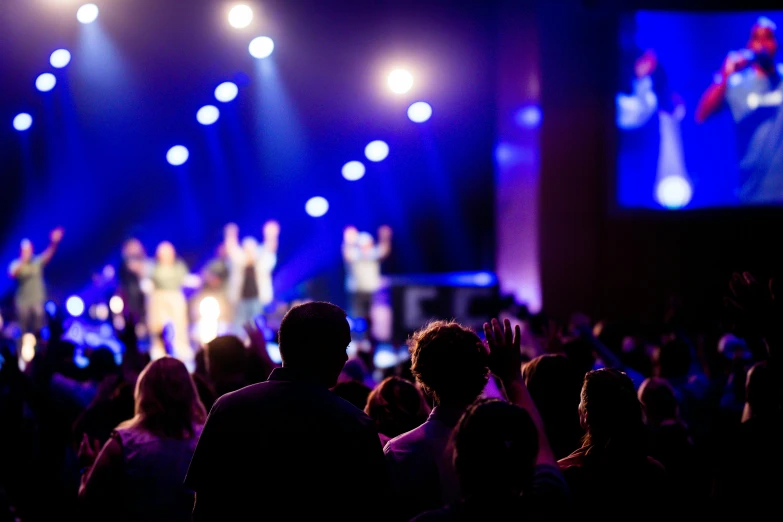 a group of people are watching as some perform