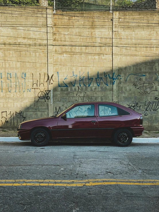 a burgundy car parked on a side walk