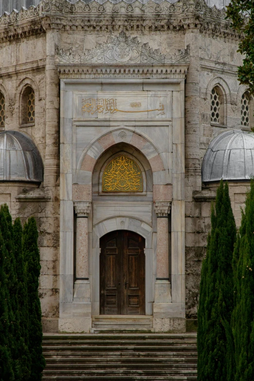 an ancient building with ornate archways and steps leading into the entrance