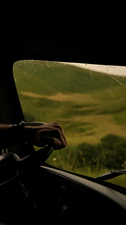 someone holding the handle of a plane steering wheel