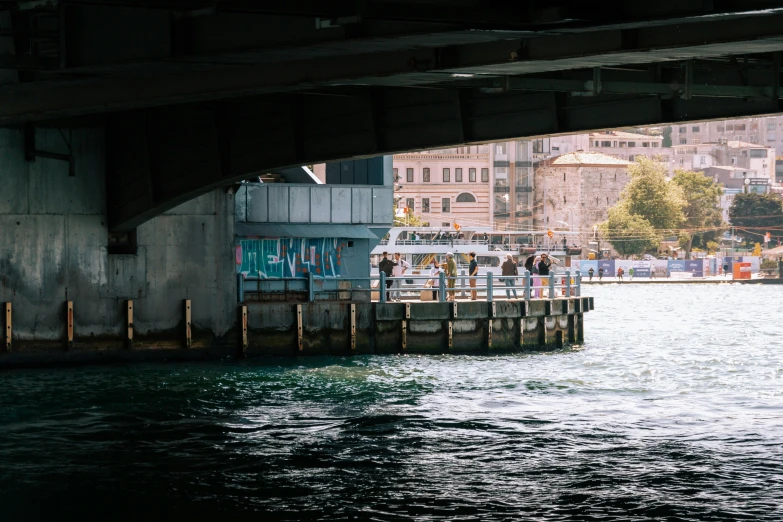 people are walking along the shore of a body of water