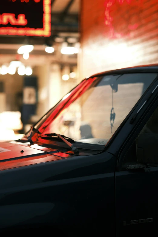 a view of the side window of a truck in front of a business