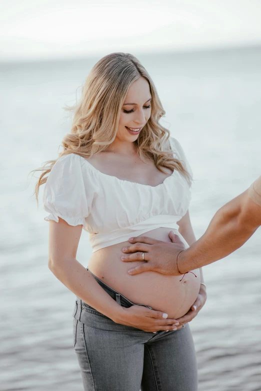 a pregnant woman holding her belly with her hands