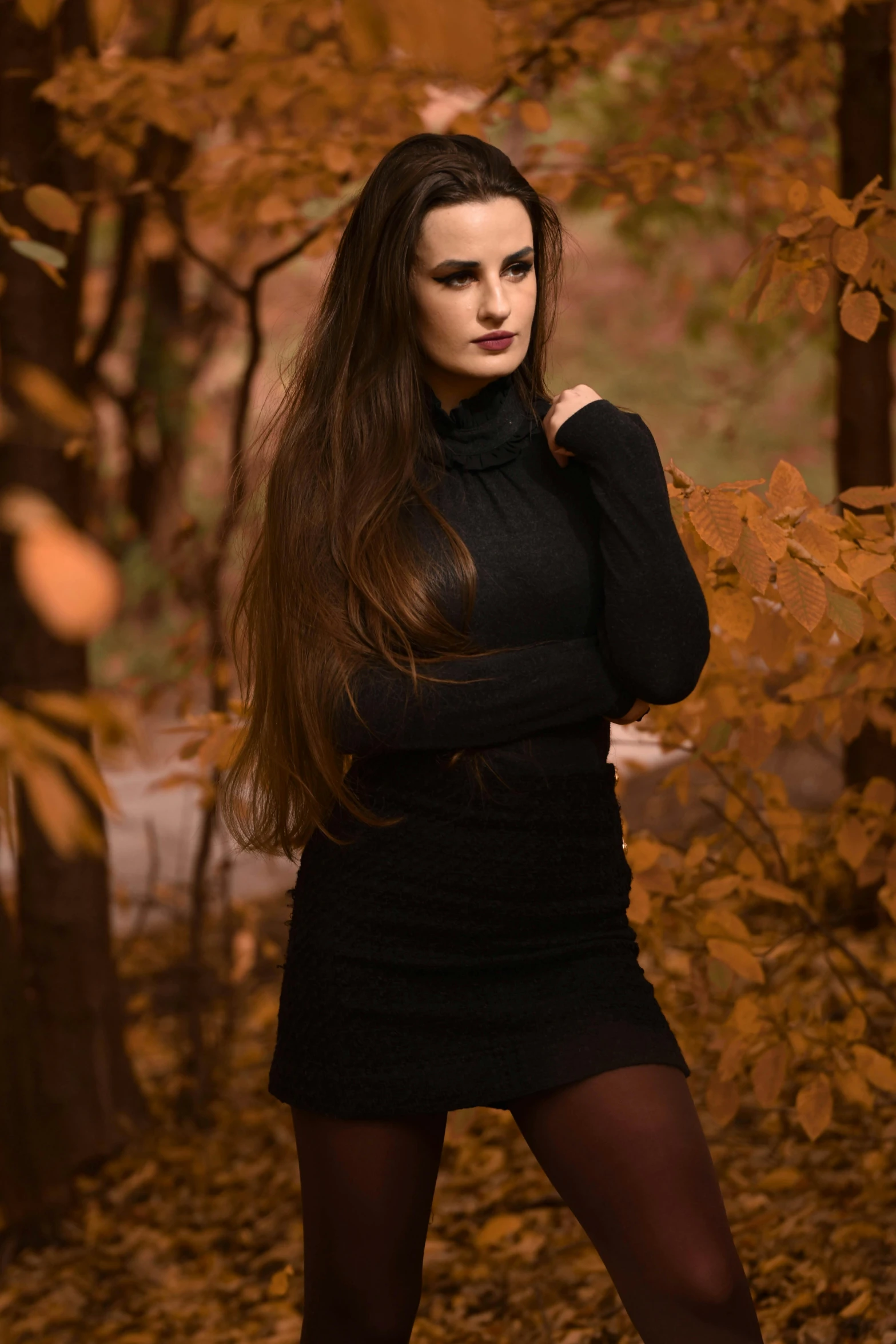 a woman with long dark hair is posing for a po