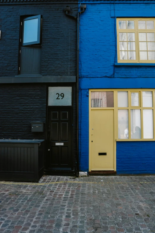 two blue buildings with the doors open