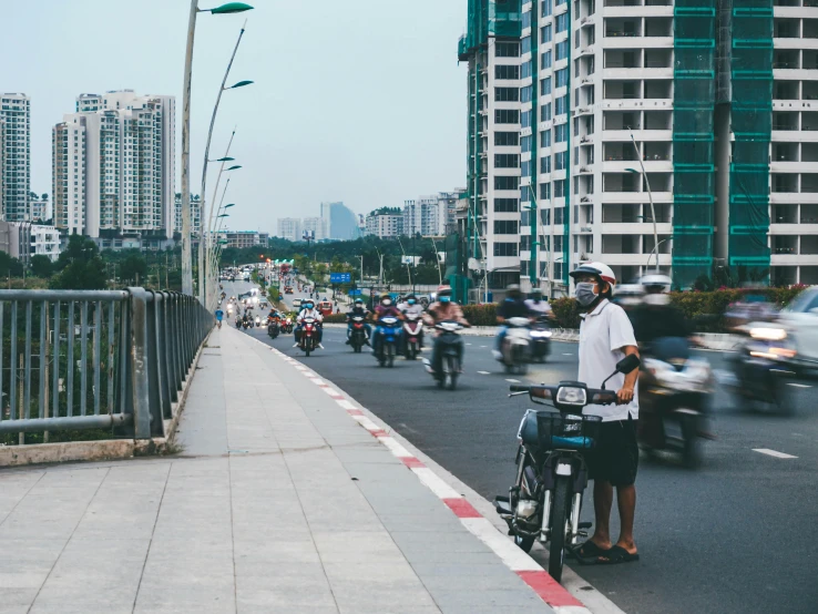 a motorcyclist and motorcyclists traveling down a busy city street