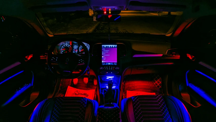 the interior of an automobile lit with colored lighting