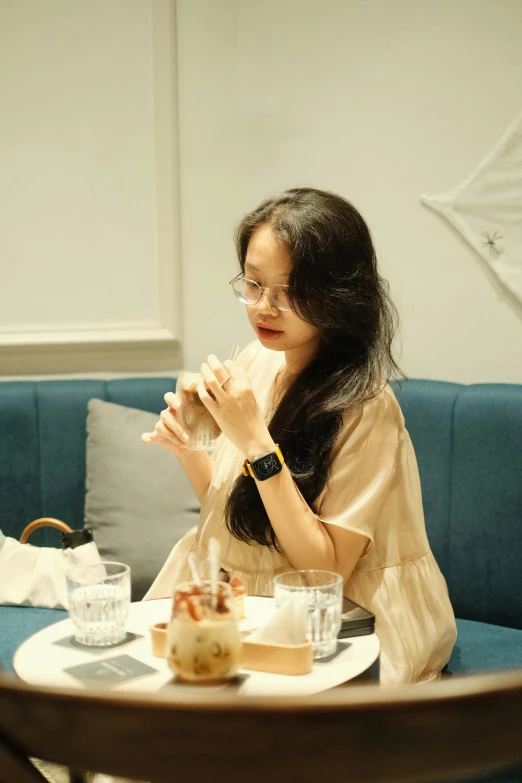 woman sitting down holding soing at a table