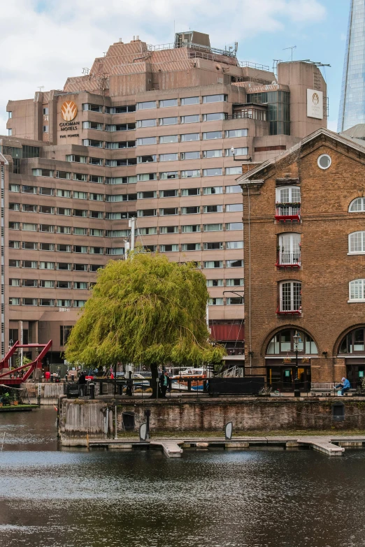 tall buildings near the water with one person walking