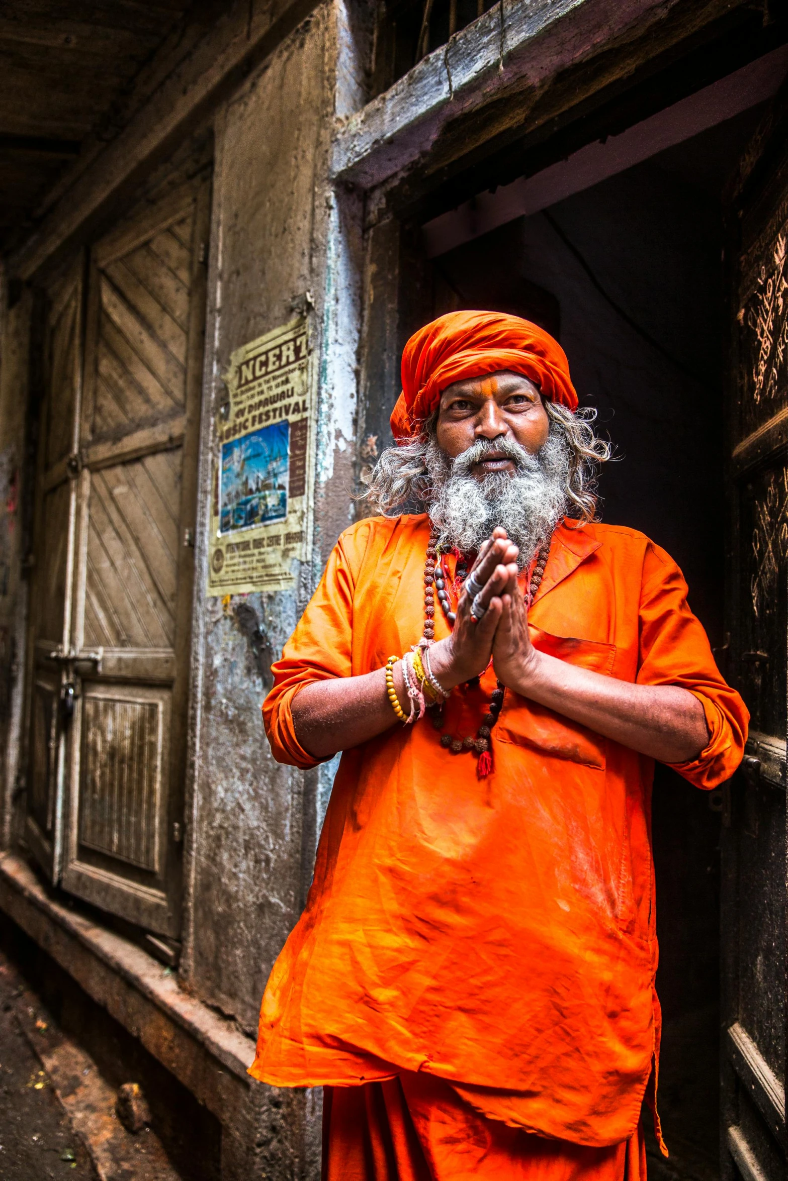 man standing in doorway holding his hand to his chest