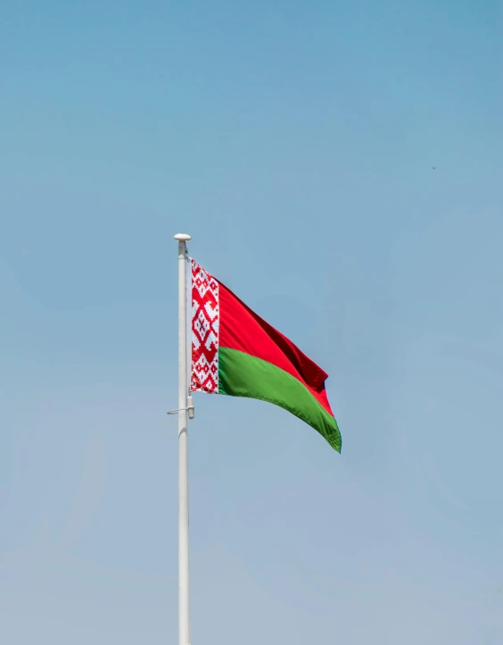 an afghan flag flying high in the sky