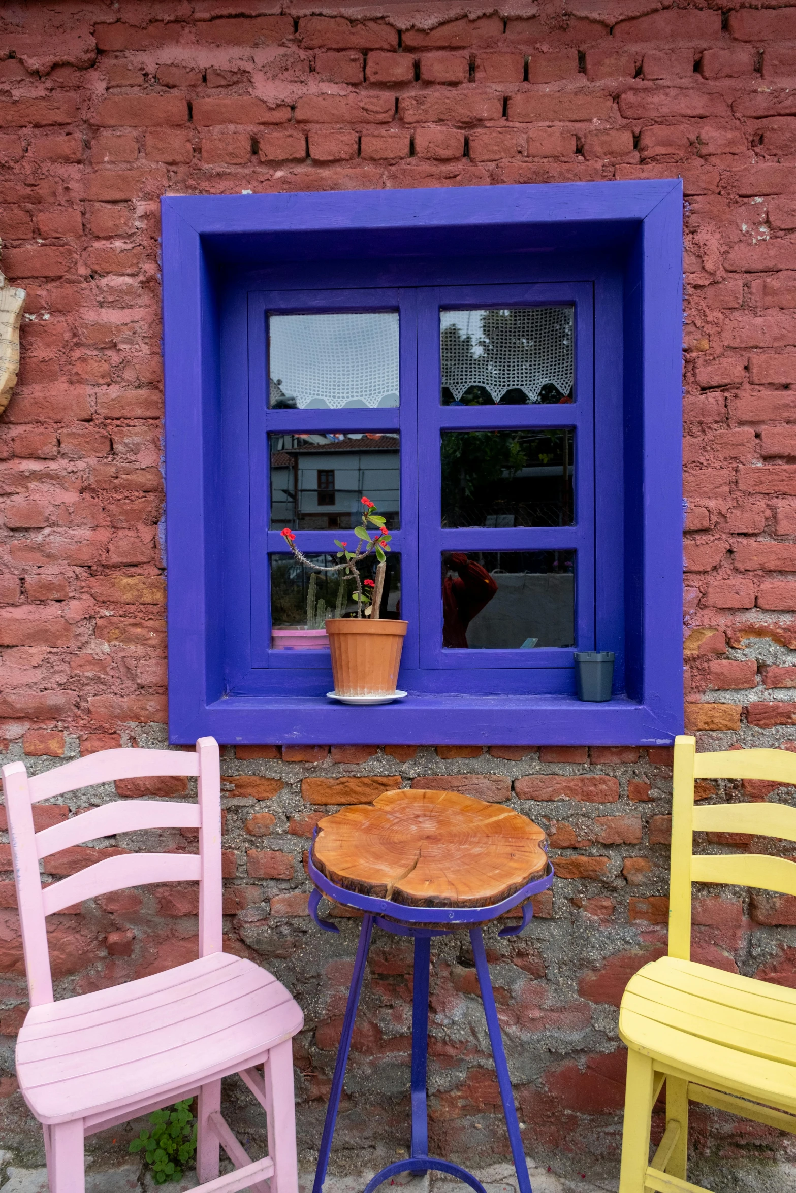 two yellow and blue chairs a table and a window