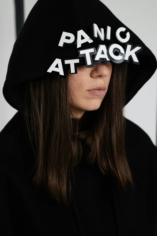 a woman wearing a black hoodie with writing on it