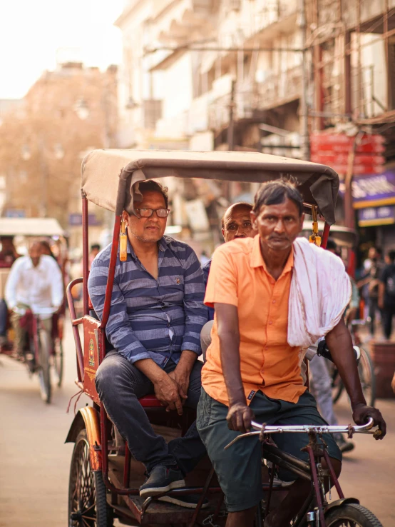 an older couple in a rickshaw going down the street